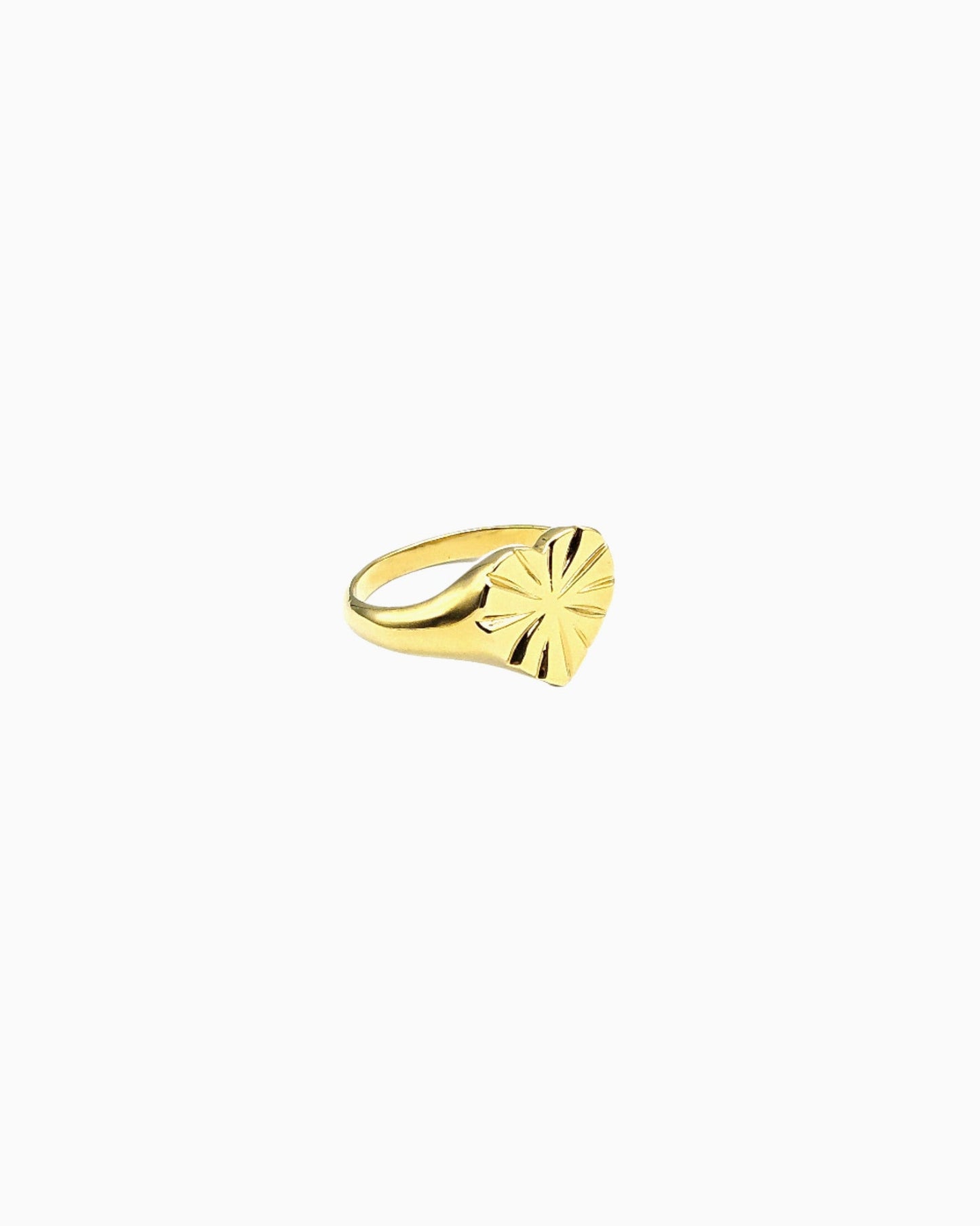 Gold heart signet ring with engraved starburst detail