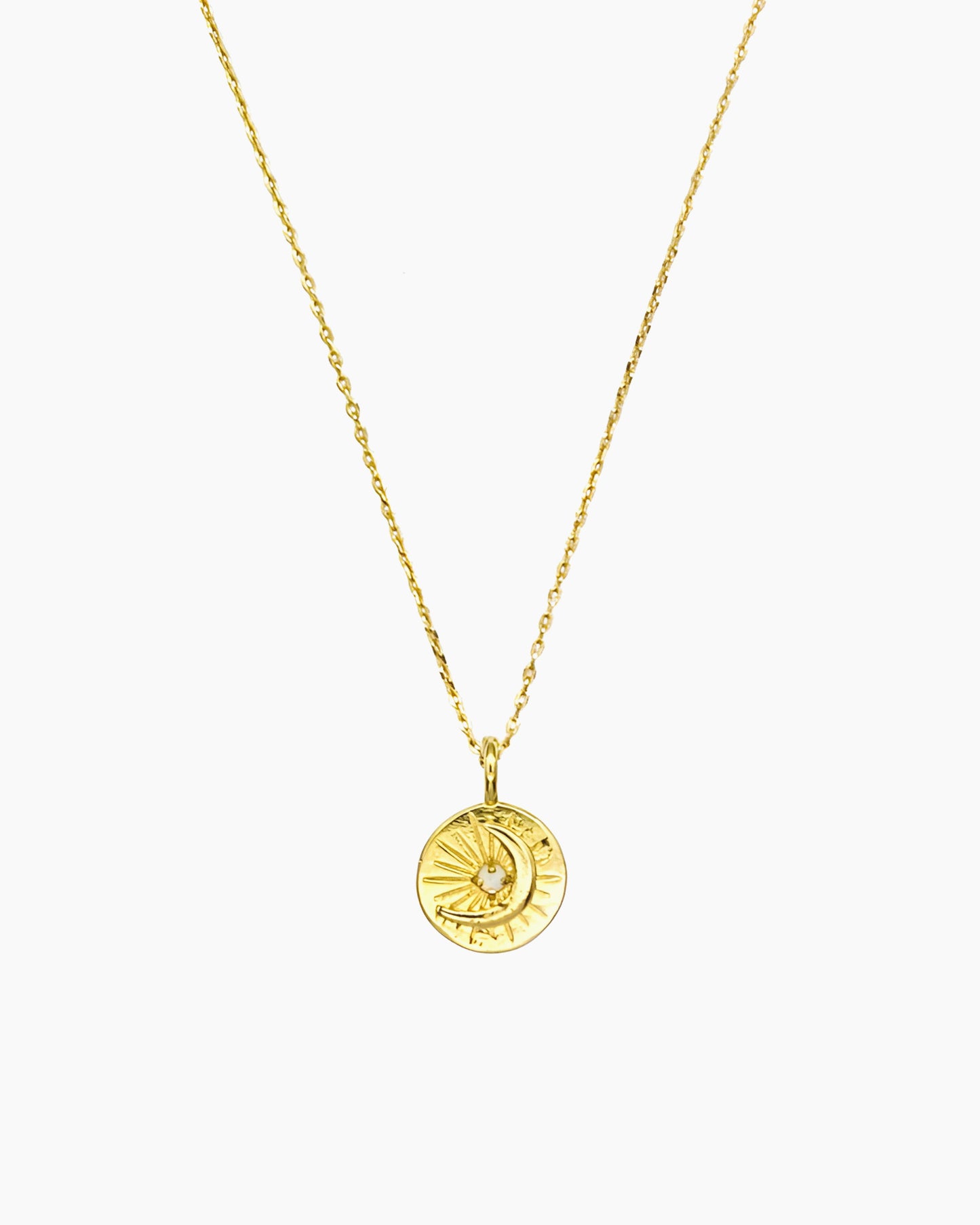 Celestial coin necklace with starburst and moon motif in gold finish