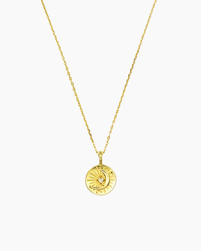 Celestial coin necklace with starburst and moon motif in gold finish