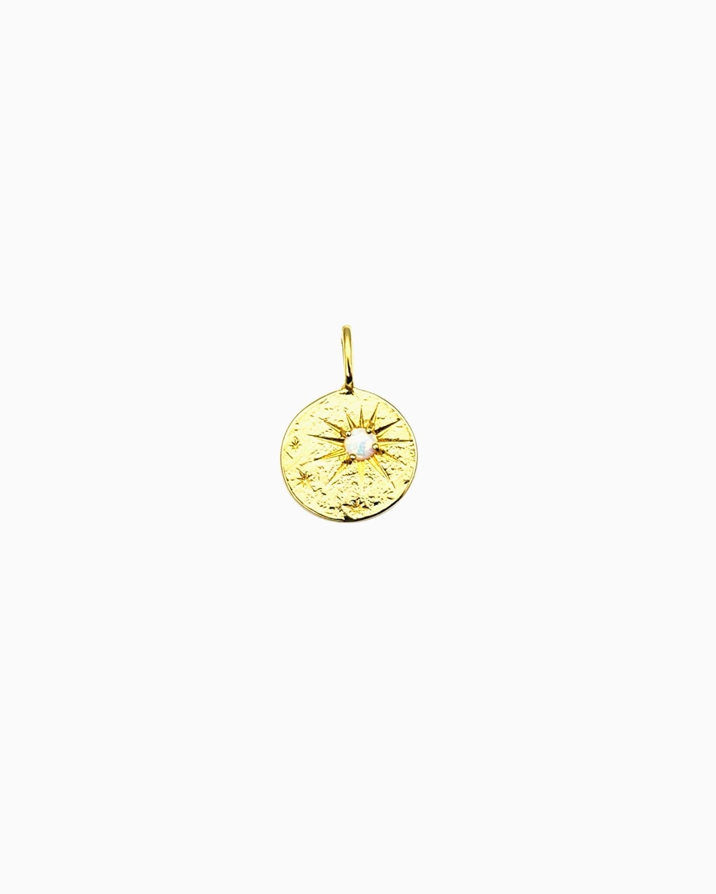 Gold clip-on coin charm with starburst engraving and a small opal center