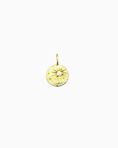 Gold clip-on coin charm with starburst engraving and a small opal center