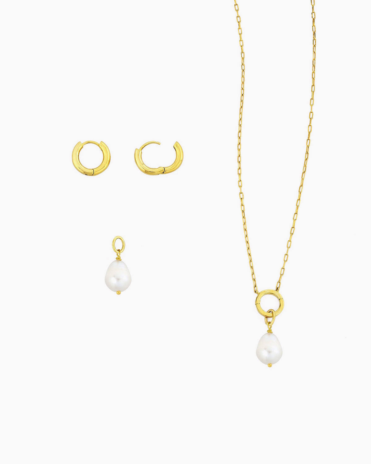Gold huggie hoops with detachable freshwater pearl charm shown with a gold charm holder necklace