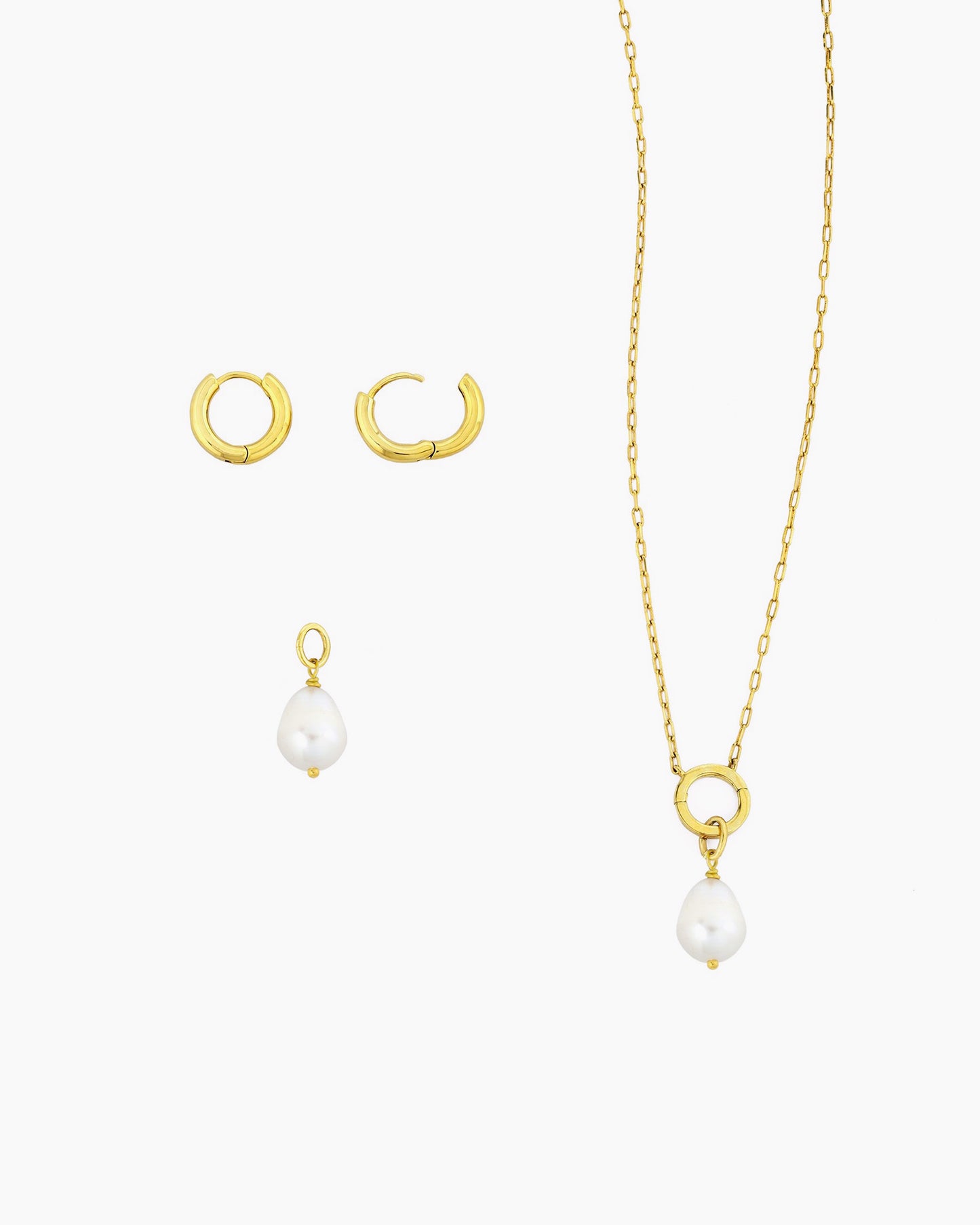 Gold huggie hoops with detachable freshwater pearl charm shown with a gold charm holder necklace
