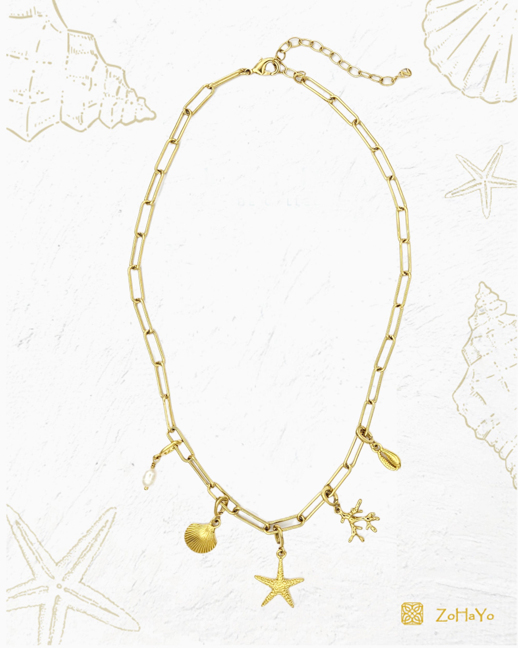 Seaside Charm Necklace with removable cowrie shell, coral branch, starfish, seashell, and  freshwater pearl clip-on charms on a gold paperclip chain