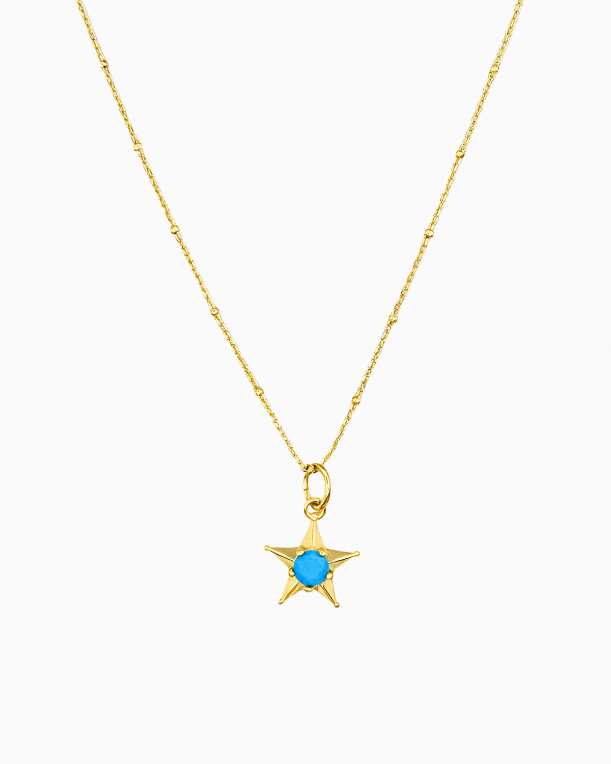 gold pvd plated star charm necklace with turquoise cz