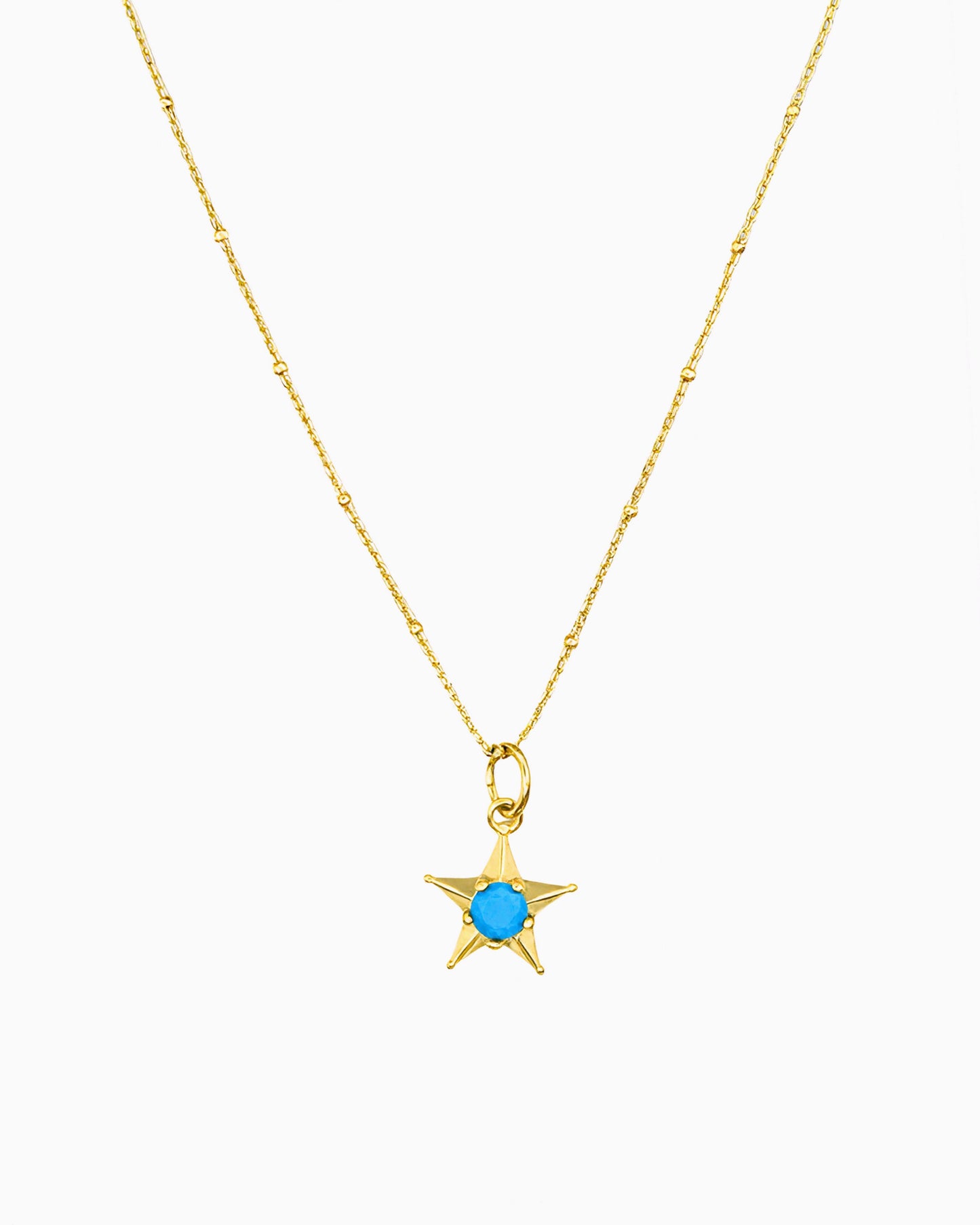 gold pvd plated star charm necklace with turquoise cz