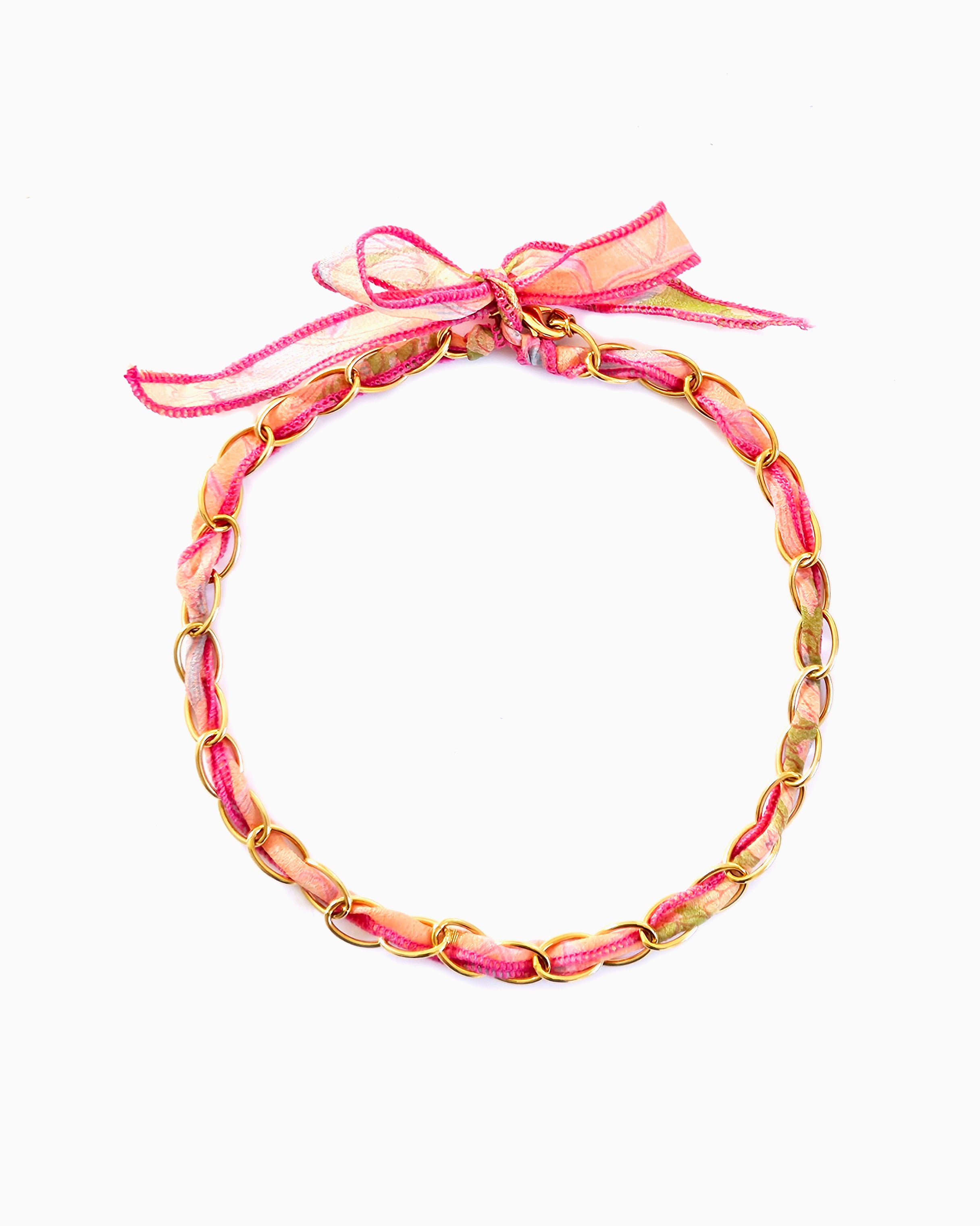 Pink Zest silk ribbon chain necklace with pink, apricot and green patterned ribbon, hot pink stitched edges, and gold oval-link chain tied in a bow