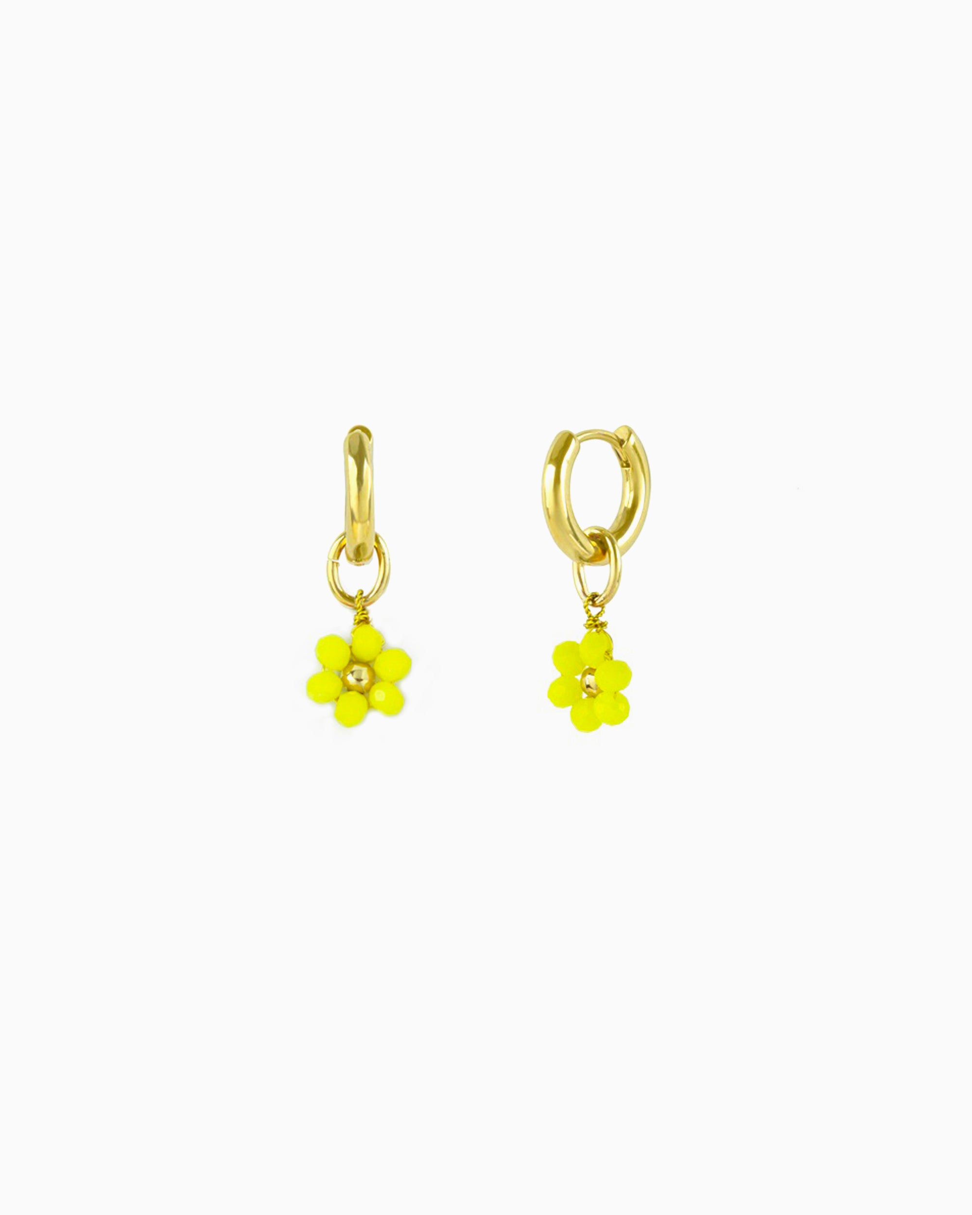 Gold huggie earrings with interchangeable yellow glass beaded flower charm.