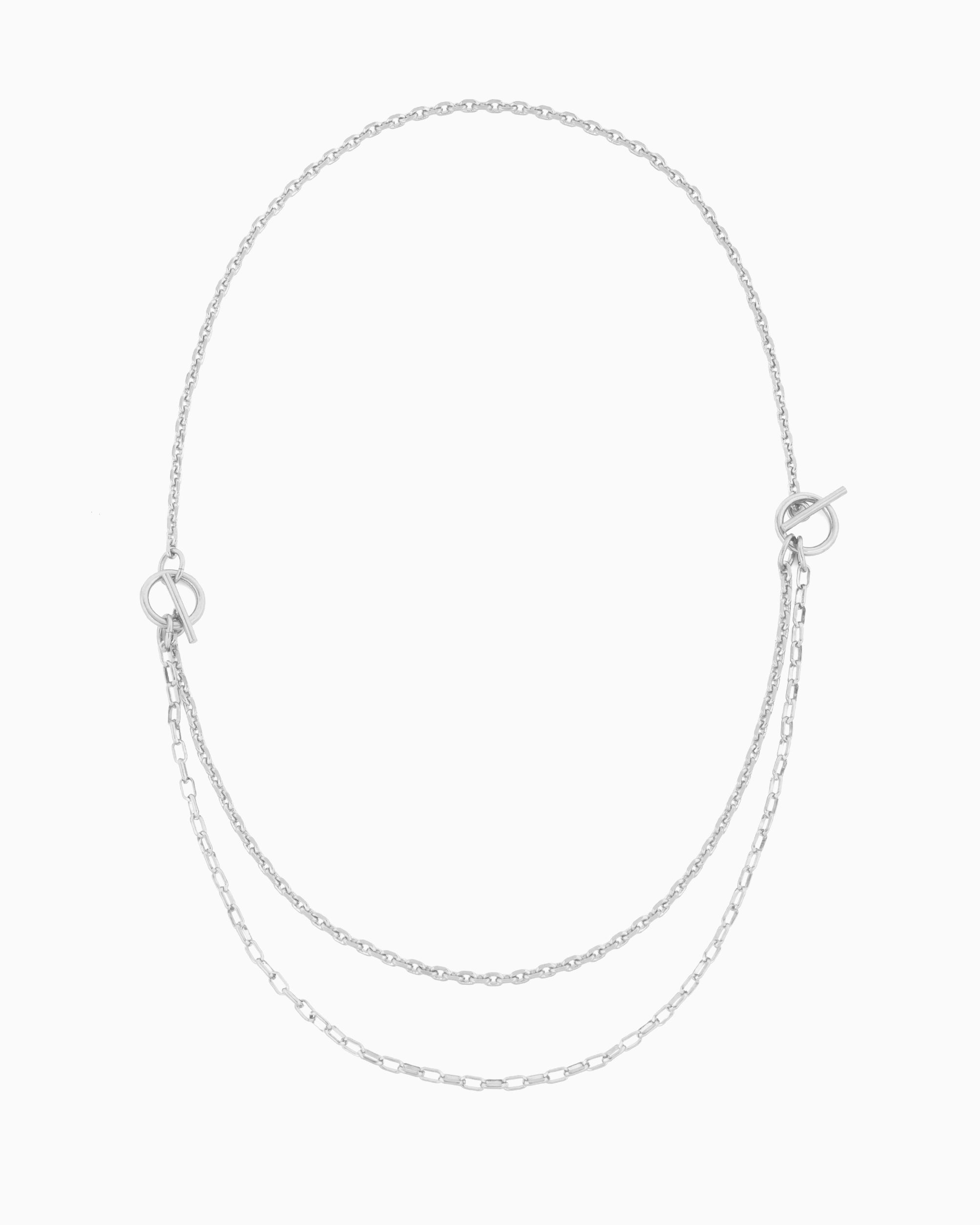Dual toggle silver chain necklace styled as a lariat and layered two-row necklace