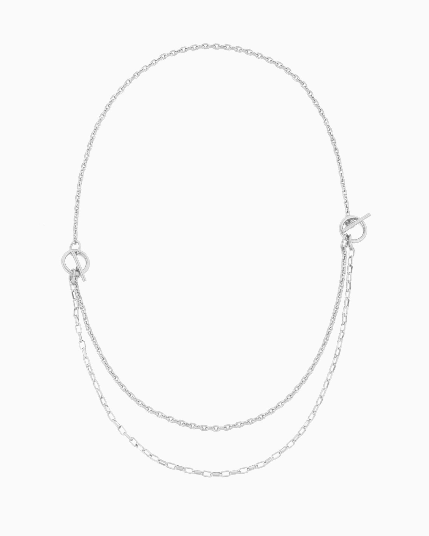 Dual toggle silver chain necklace styled as a lariat and layered two-row necklace