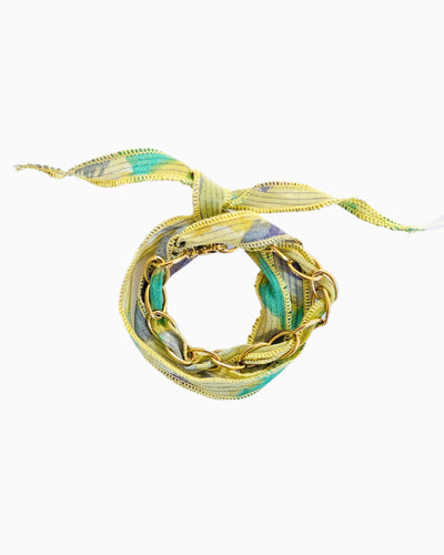 Gold chain bracelet with silk ribbon woven through links