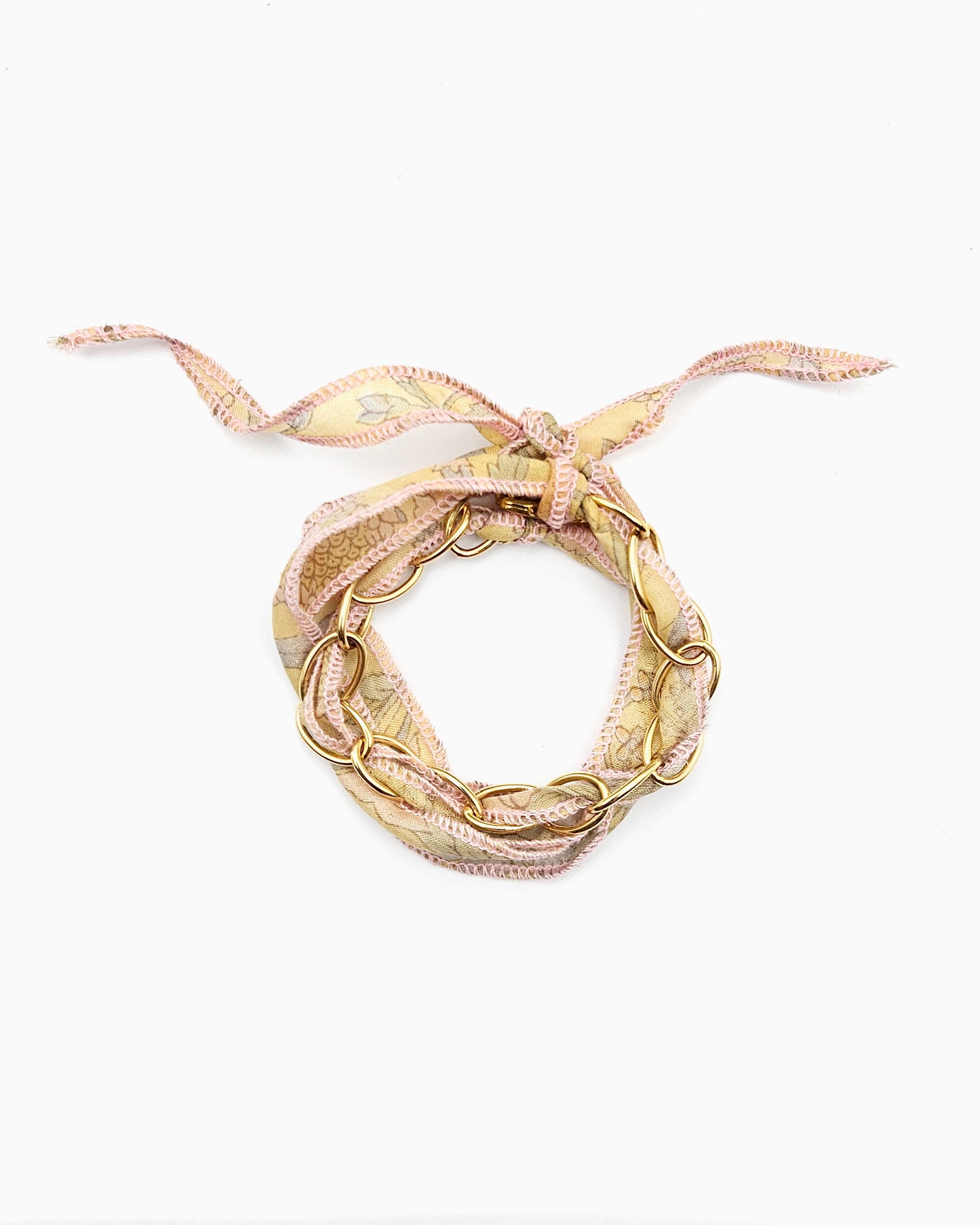 Gold chain bracelet with silk ribbon woven through links