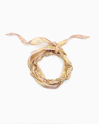 Gold chain bracelet with silk ribbon woven through links