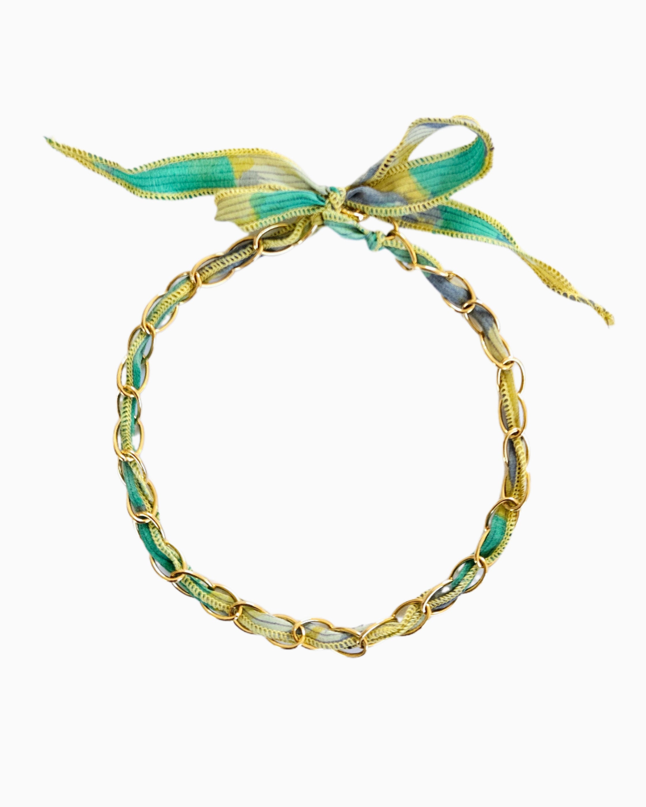 Gold chain necklace with silk ribbon woven through links