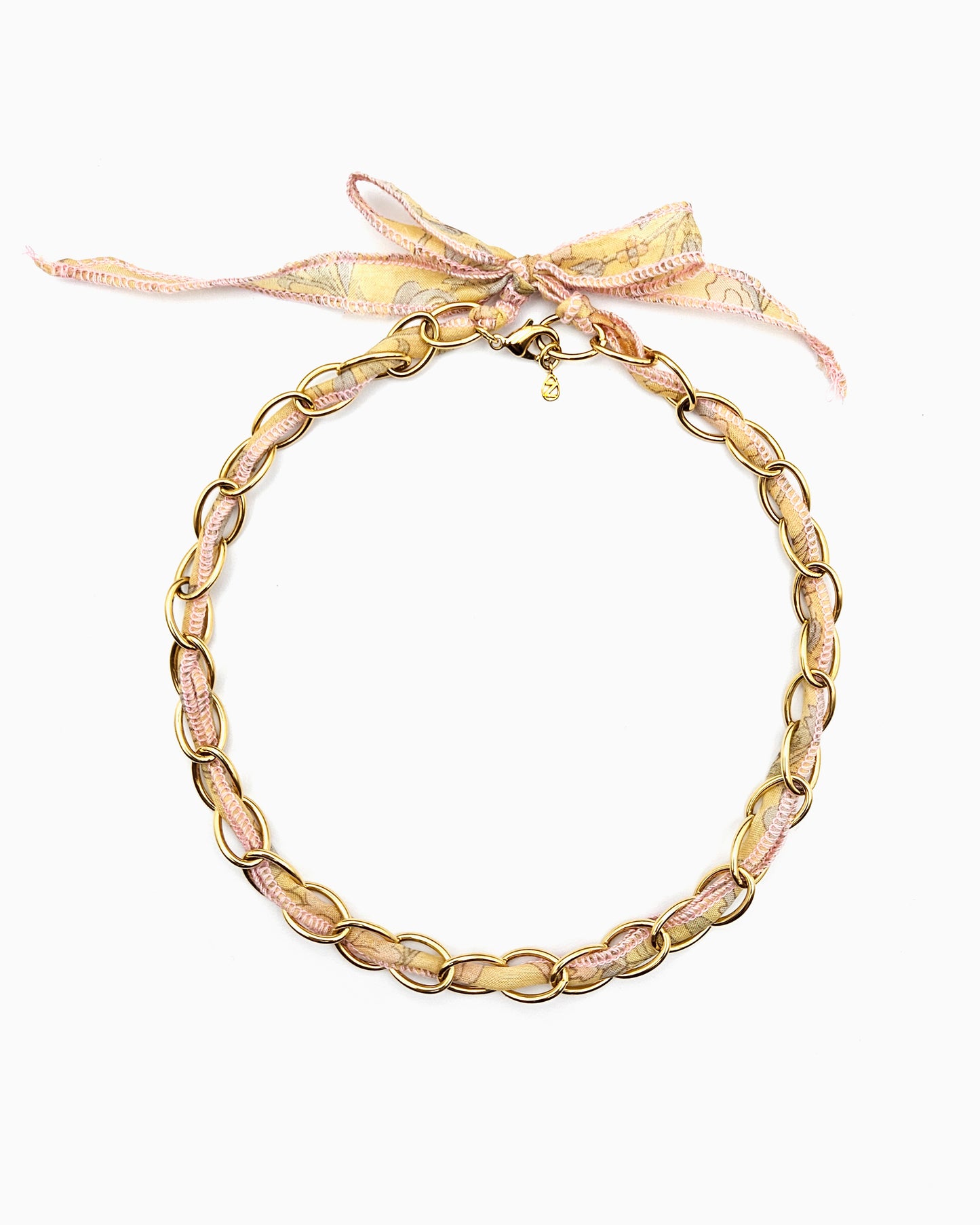 Gold chain necklace with silk ribbon woven through links