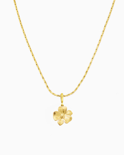 gold flower charm necklace with clip-on charm on delicate chain