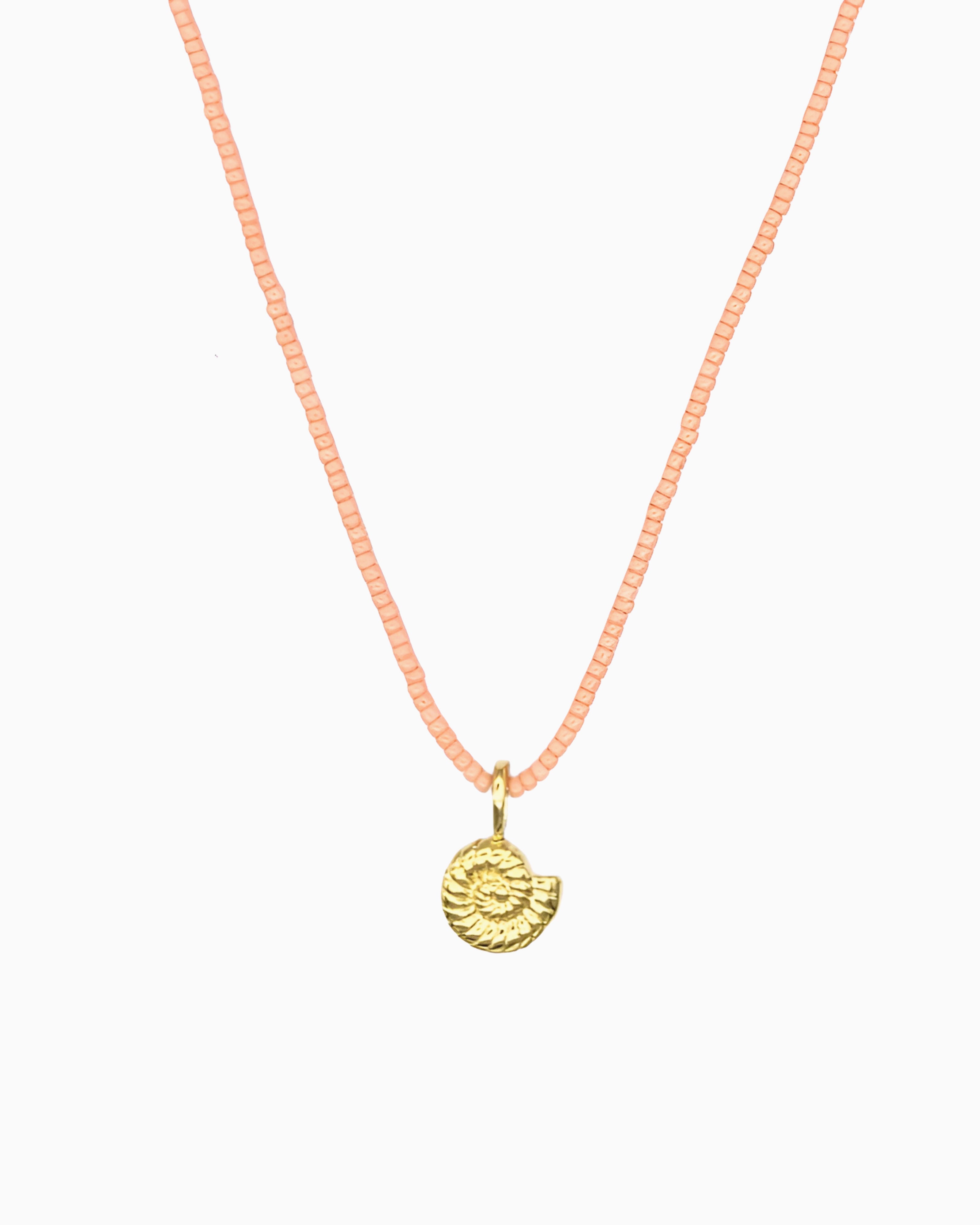 Peach Coral Nautilus Necklace featuring a delicate curb chain strand, peach coral Miyuki seed bead strand, and removable nautilus clip-on charm.