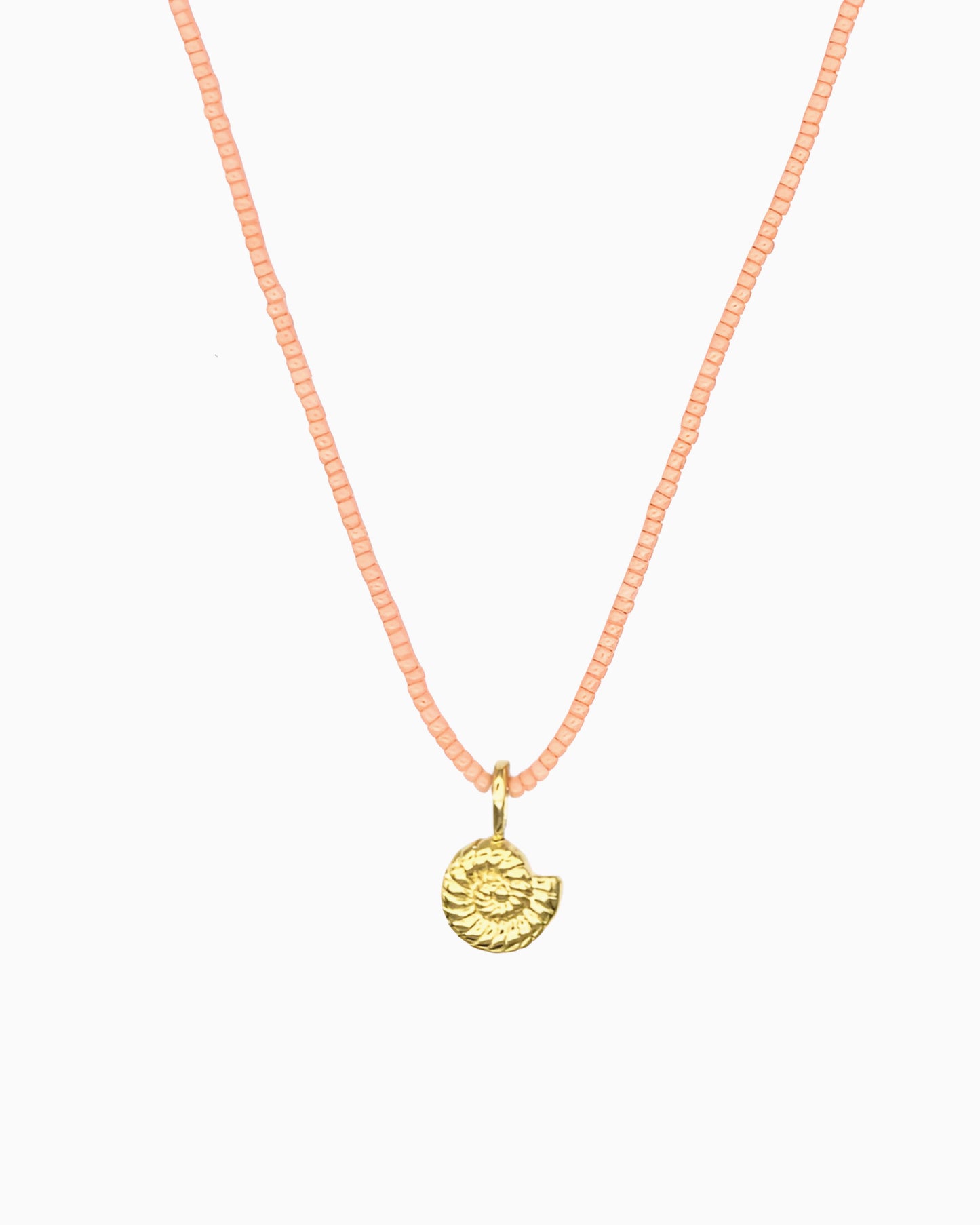 Peach Coral Nautilus Necklace featuring a delicate curb chain strand, peach coral Miyuki seed bead strand, and removable nautilus clip-on charm.