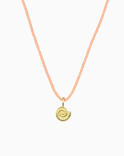 Peach Coral Nautilus Necklace featuring a delicate curb chain strand, peach coral Miyuki seed bead strand, and removable nautilus clip-on charm.