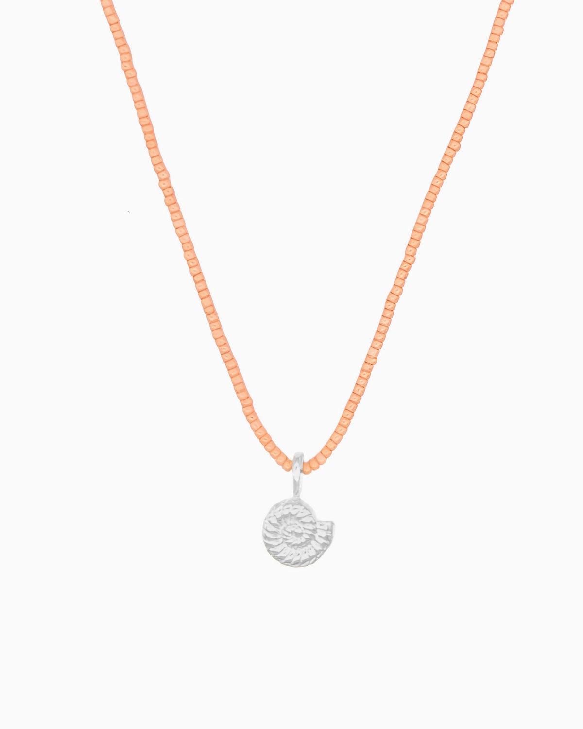 Peach Coral Nautilus Necklace featuring a delicate curb chain strand, peach coral Miyuki seed bead strand, and removable nautilus clip-on charm in silver