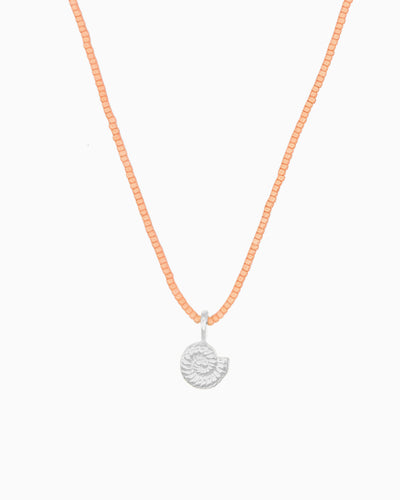 Peach Coral Nautilus Necklace featuring a delicate curb chain strand, peach coral Miyuki seed bead strand, and removable nautilus clip-on charm in silver