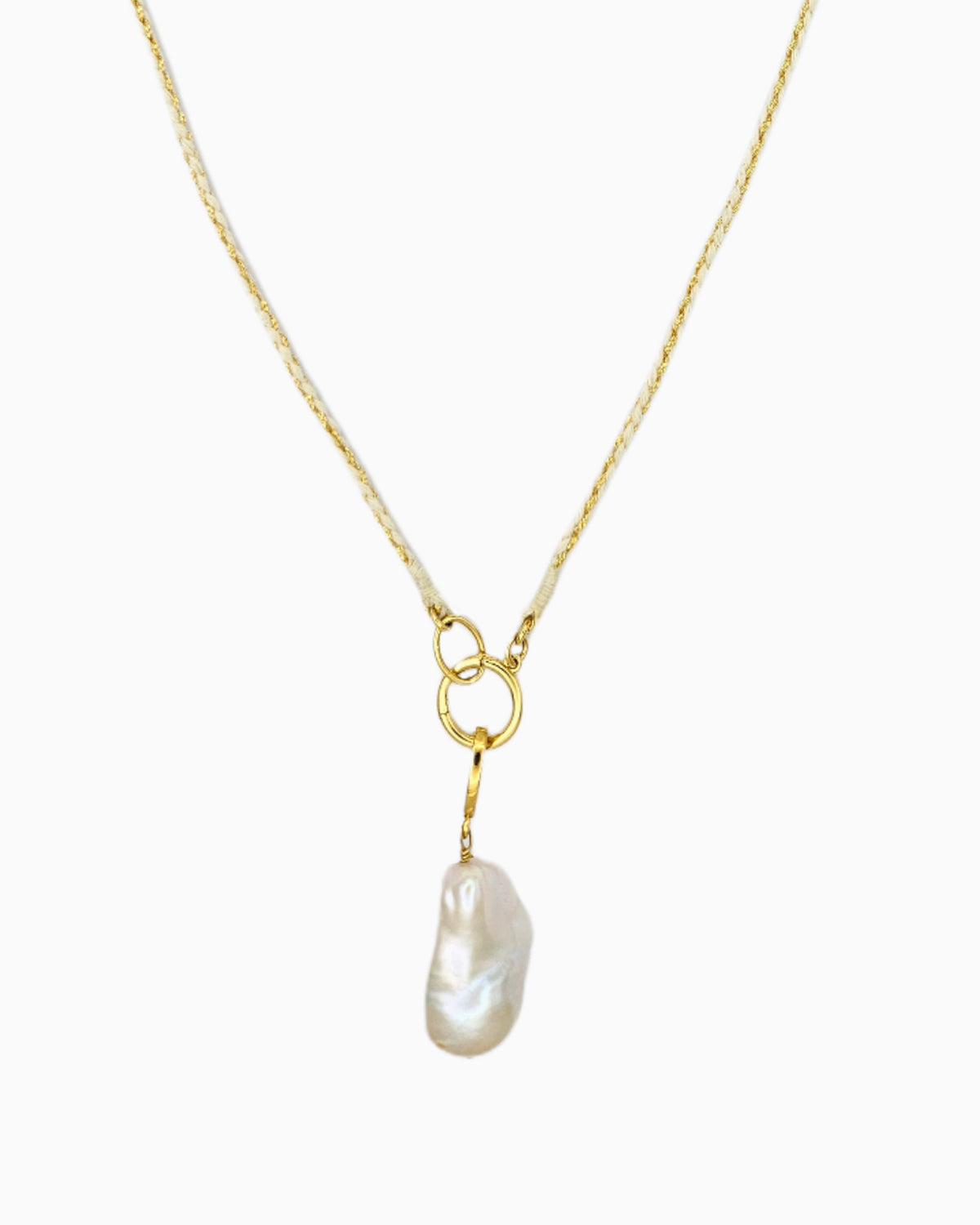 Braided ivory and gold cord necklace with a detachable baroque freshwater pearl pendant and hinged charm holder.