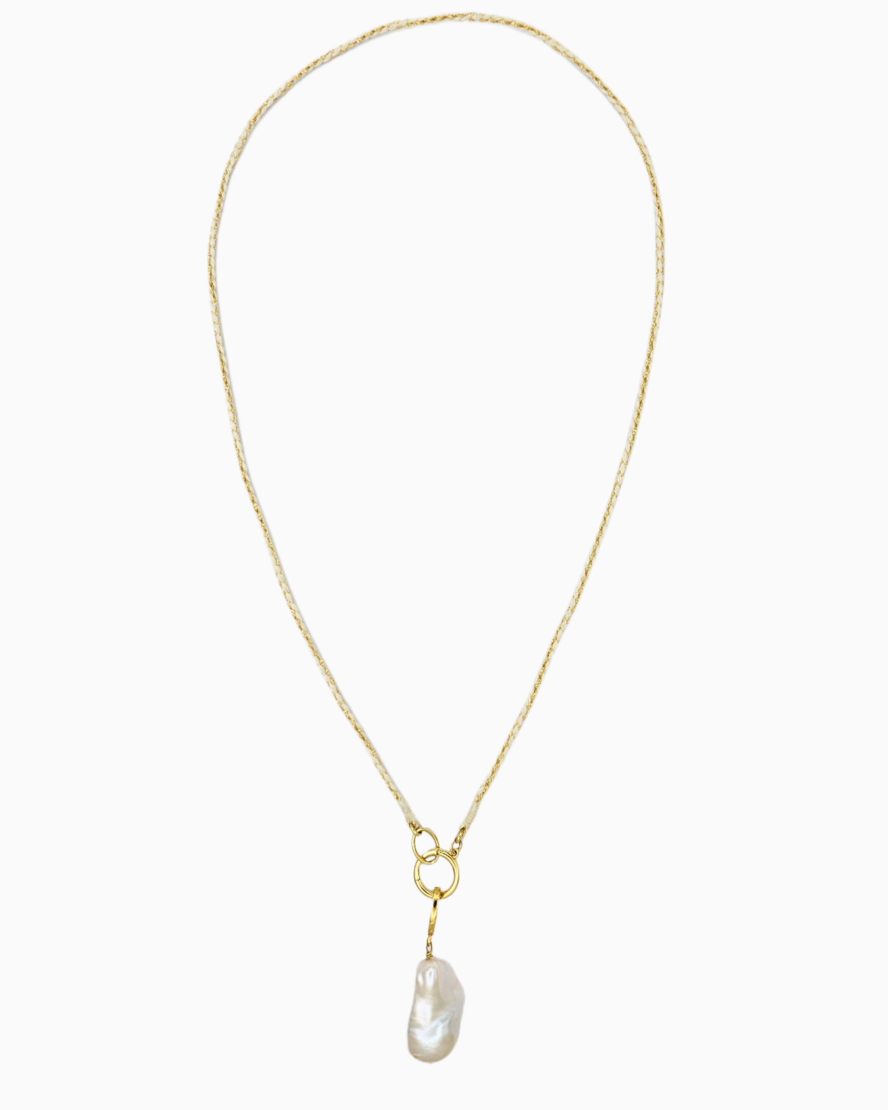 Braided ivory and gold cord necklace with a detachable baroque freshwater pearl pendant and hinged charm holder.