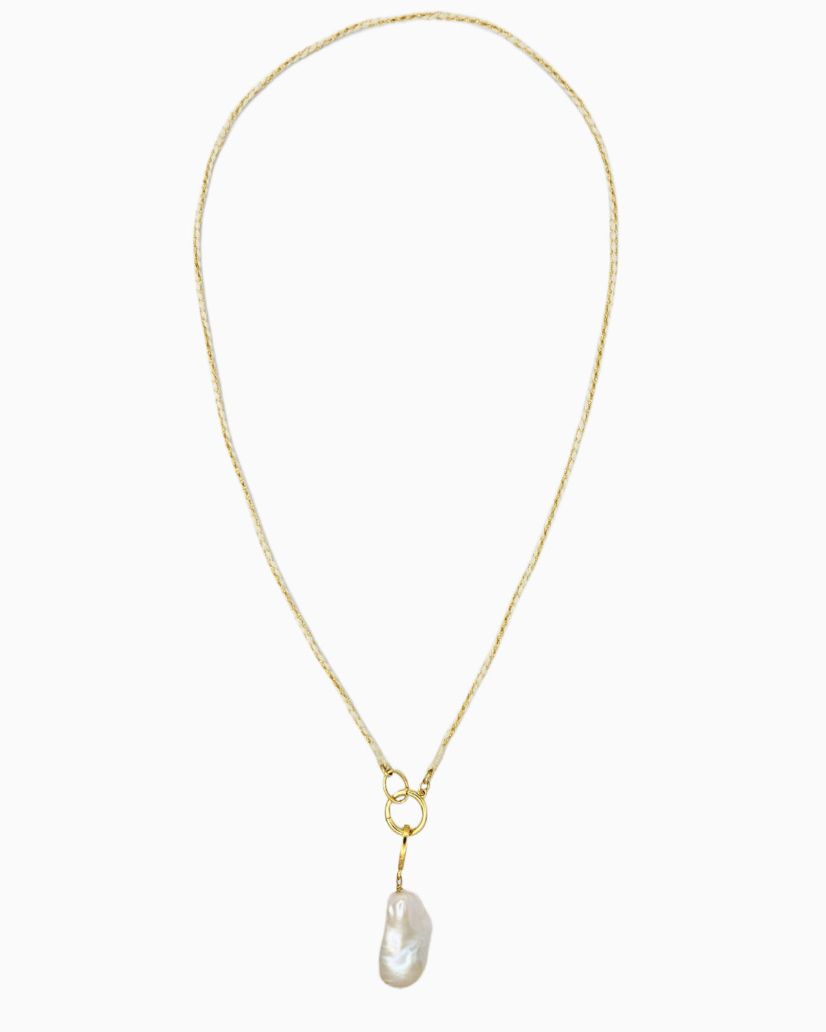 Braided ivory and gold cord necklace with a detachable baroque freshwater pearl pendant and hinged charm holder.