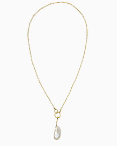 Braided ivory and gold cord necklace with a detachable baroque freshwater pearl pendant and hinged charm holder.