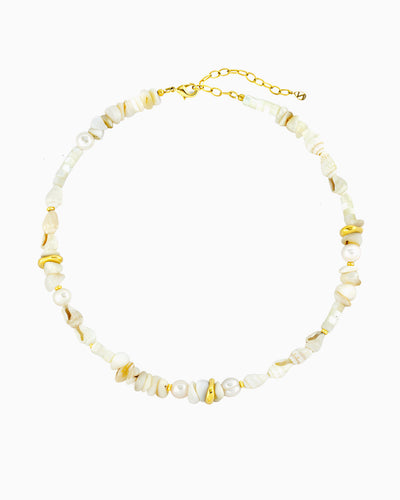 Coastal-inspired necklace featuring freshwater pearls, seashells, mother-of-pearl beads, and polished gold accents