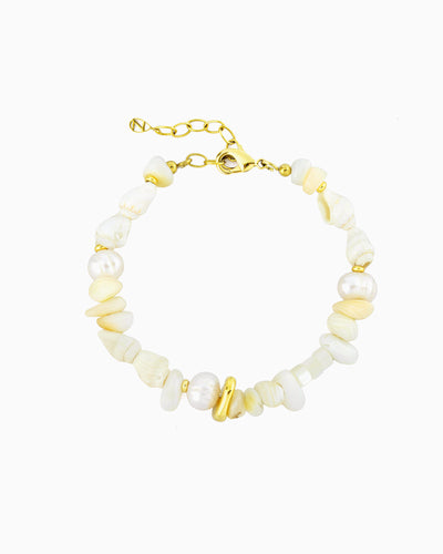 Coastal-inspired bracelet featuring freshwater pearls, seashells, mother-of-pearl beads, and polished gold accents