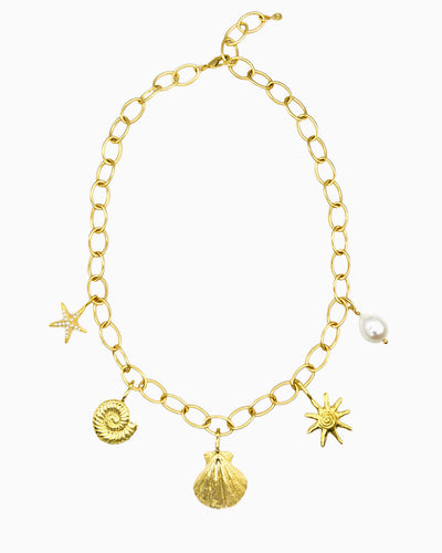 Coastal Treasures Charm Necklace featuring detachable pearl detailed starfish, nautilus, seashell, sunray, and freshwater pearl charms on a gold oval link chain.