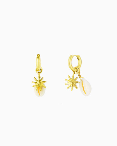 Convertible gold huggie hoops featuring detachable sunray and cowrie shell charms