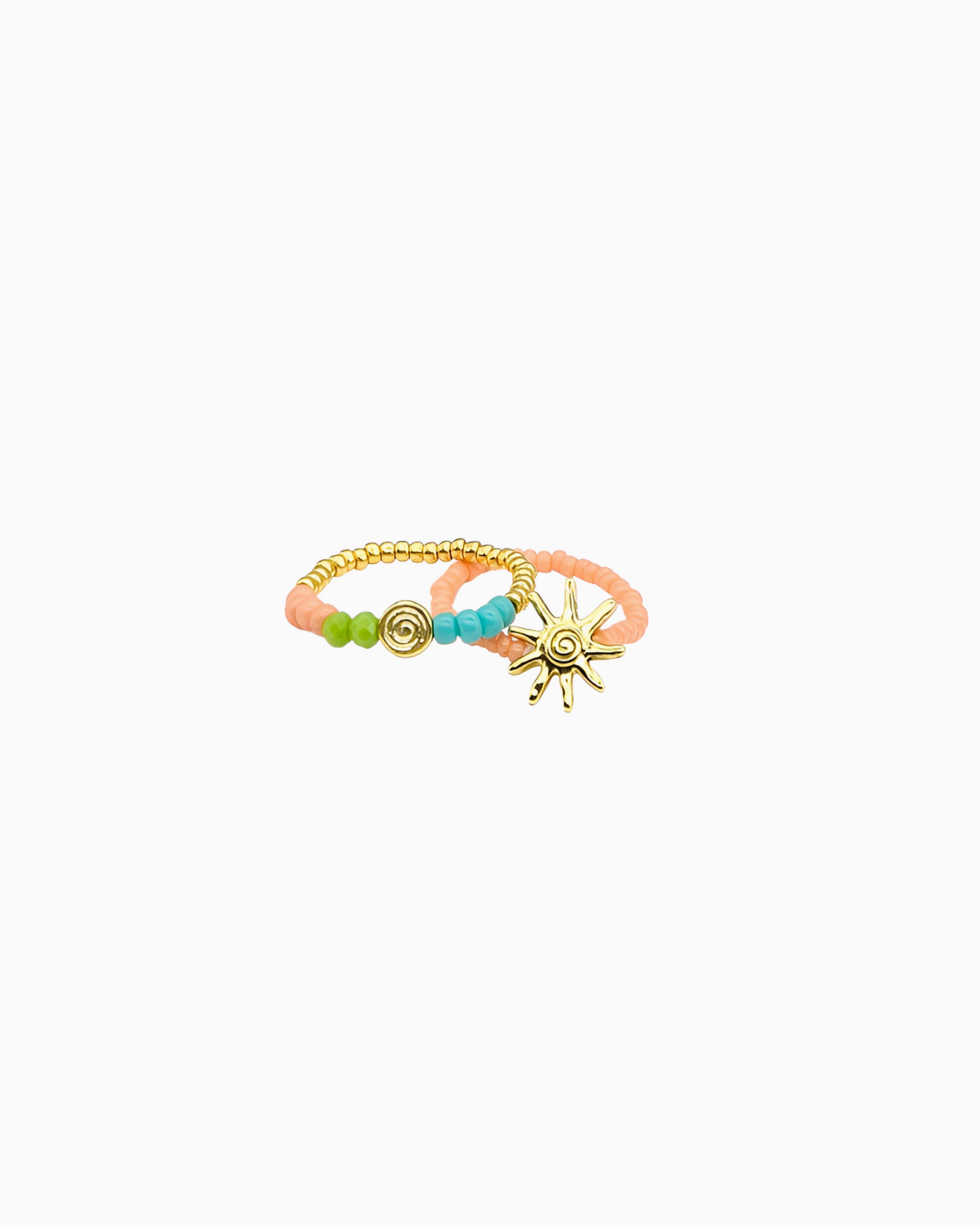 A playful ring featuring colorful beads, gold-tone accents, and sunray-inspired details. Inspired by sunny days by the sea, it adds a cheerful coastal touch to any jewelry stack.
