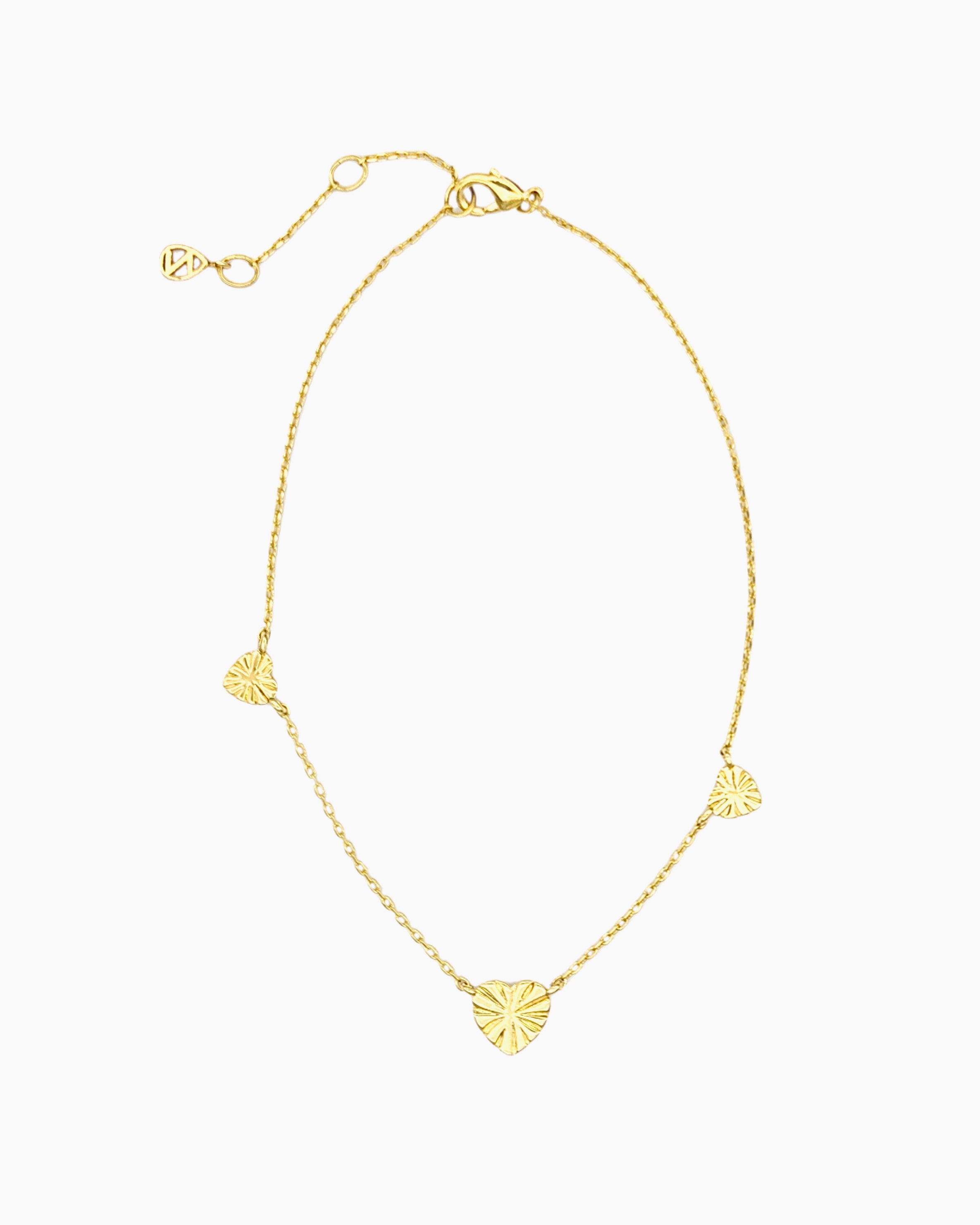 Gold starburst heart anklet with three heart stations